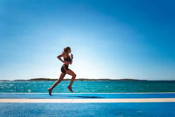 Woman running showing strong leg muscle Stowmarket